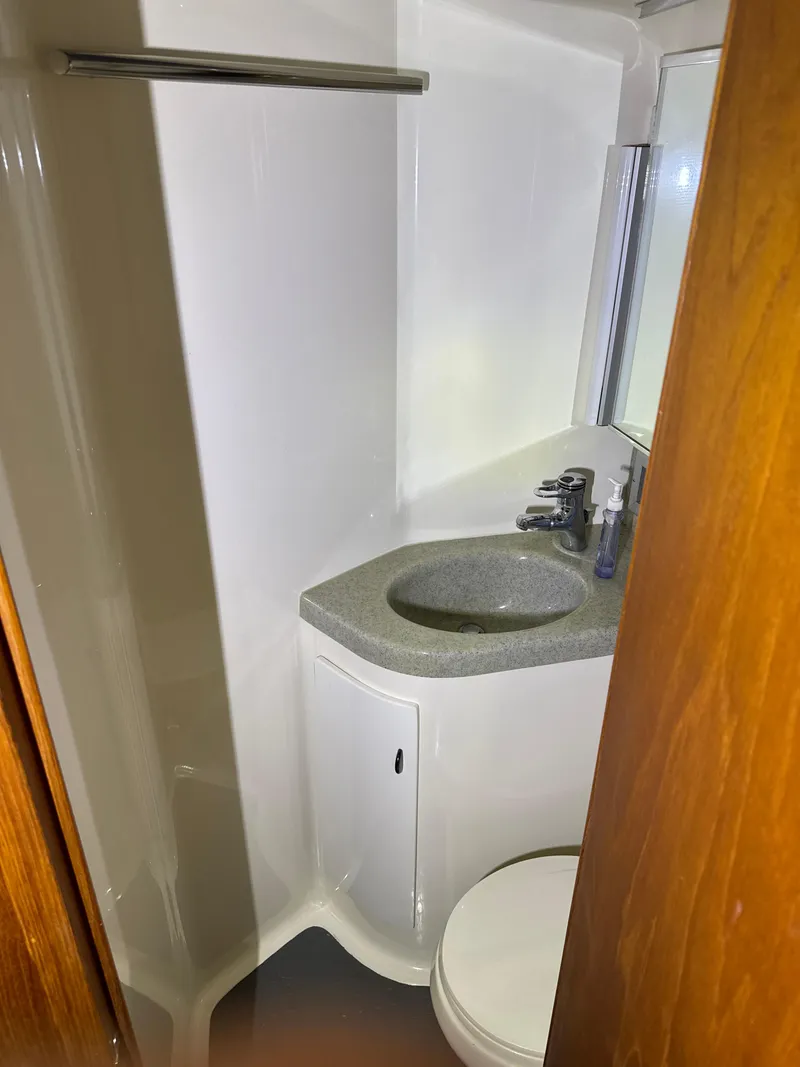 Slide: The Image of Bathroom interior of 1990 Tiara Yachts 4300 Convertible with sink and toilet. - 49