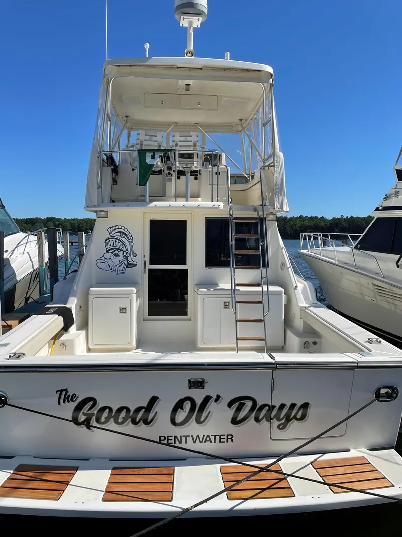 Slide: The Image of 1990 Tiara Yachts 4300 Convertible docked, named "The Good Ol' Days," in Pentwater marina. - 6
