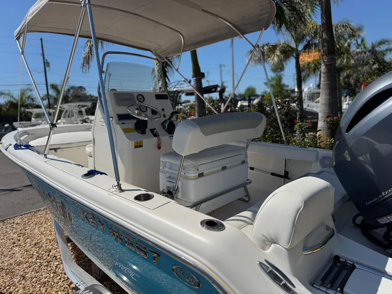 Slide: The Image of 2022 Key West 189 FS boat with canopy, console, and seating, displayed outdoors. - 10