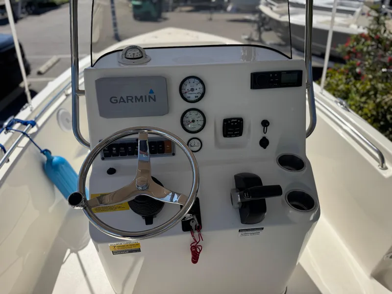 Slide: The Image of 2022 Key West 189 FS boat console with Garmin navigation and steering wheel. - 12