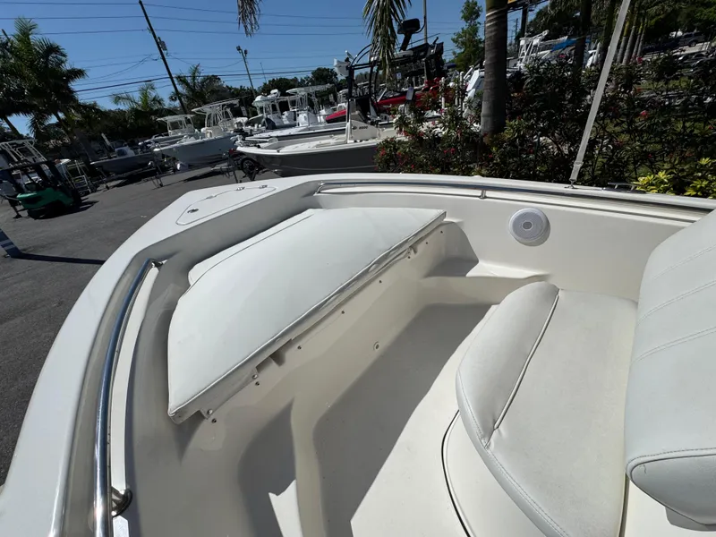 Slide: The Image of 2022 Key West 189 FS boat interior with seating and storage, displayed outdoors. - 15