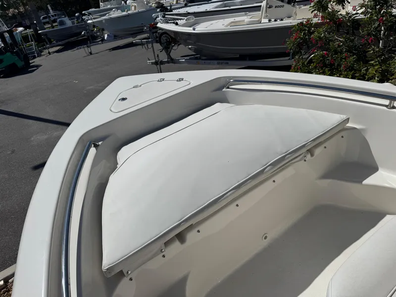 Slide: The Image of 2022 Key West 189 FS boat bow seating area in a marina setting. - 16