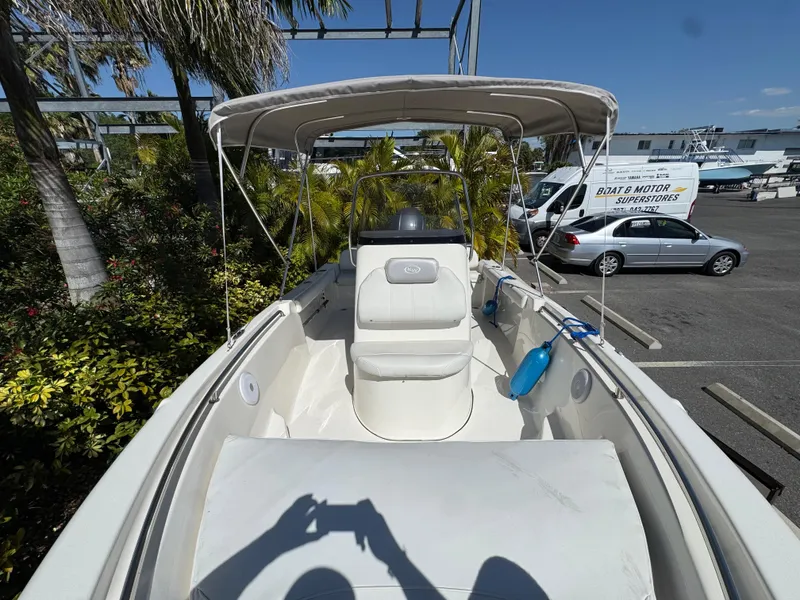 Slide: The Image of 2022 Key West 189 FS boat with canopy, parked in a marina. - 17