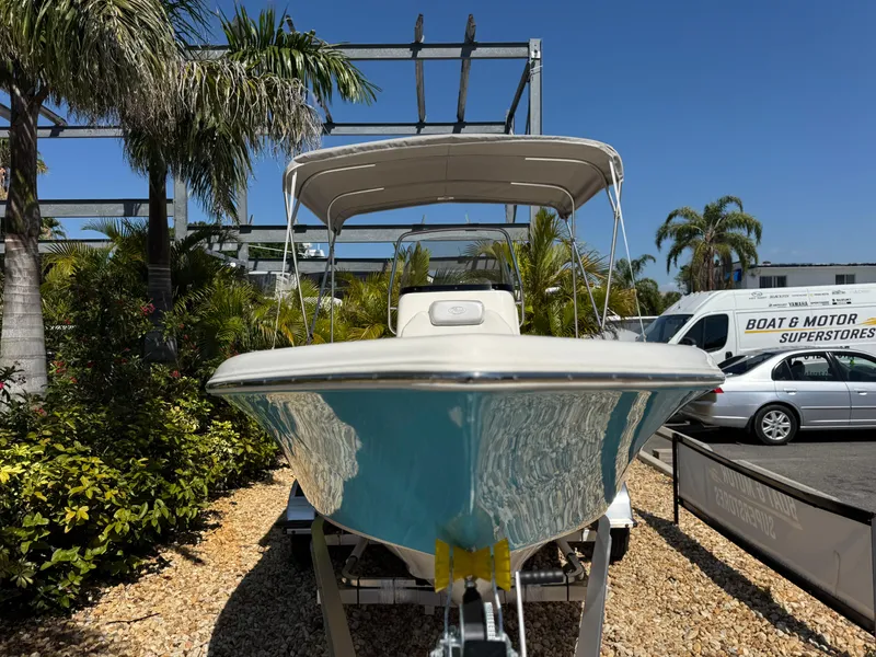 Slide: The Image of 2022 Key West 189 FS boat on display, surrounded by tropical plants and vehicles. - 3