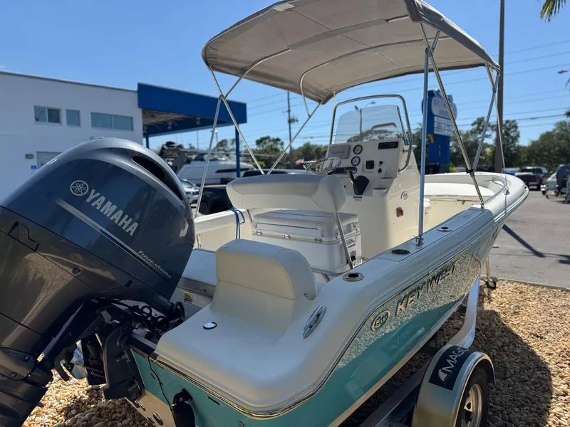 Slide: The Image of 2022 Key West 189 FS boat with Yamaha engine, parked outdoors under sunny skies. - 7