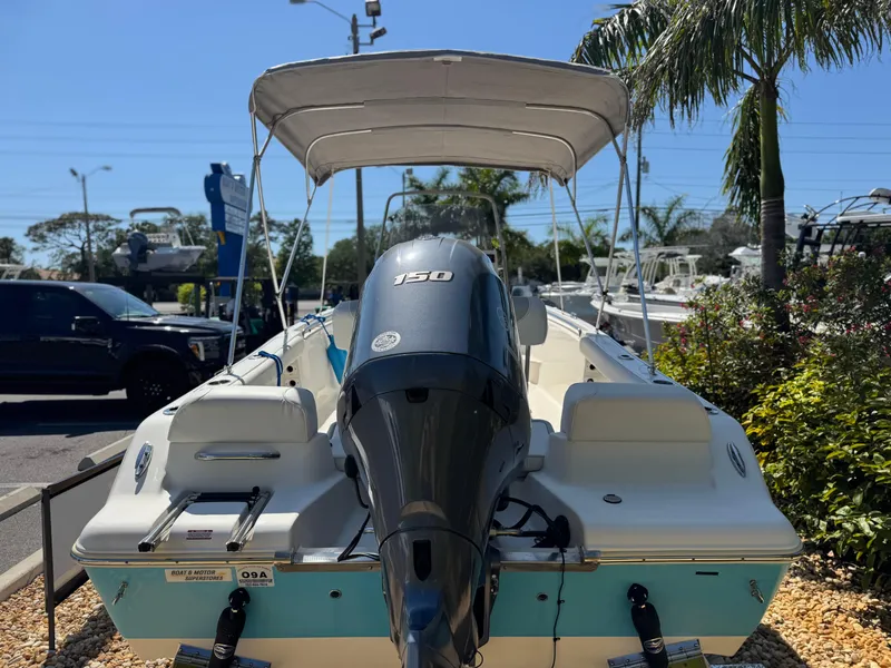 Slide: The Image of 2022 Key West 189 FS boat with outboard motor and canopy, parked outdoors. - 8