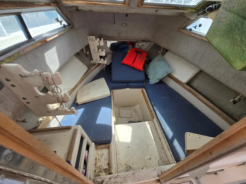 Slide: The Image of 1991 Grady-White 24 Offshore cabin interior with cushions and life jackets. - 11