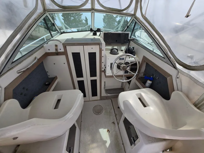 Slide: The Image of 1991 Grady-White 24 Offshore boat interior with dual seats and steering wheel. - 4