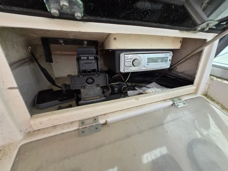Slide: The Image of 1991 Grady-White 24 Offshore boat dashboard with radio and control panel. - 8