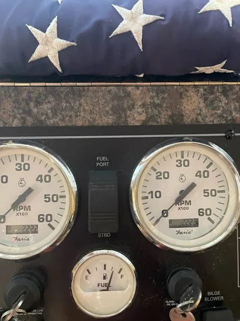 Slide: The Image of Dashboard of a 2016 Sunstar 16x58 boat with RPM gauges and American flag cushion. - 10