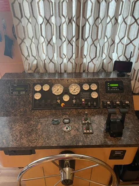 Slide: The Image of Control panel of a 2016 Sunstar 16x58 boat with gauges and steering wheel. - 11
