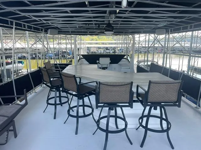 Slide: The Image of Upper deck of 2016 Sunstar 16x58 houseboat with bar seating and canopy. - 12
