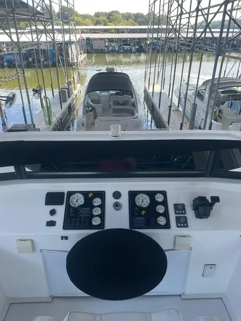 Slide: The Image of Control panel of a 2016 Sunstar 16x58 houseboat docked at a marina. - 13