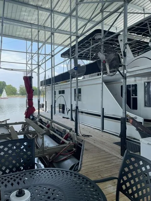 Slide: The Image of 2016 Sunstar 16x58 houseboat docked under a covered marina. - 15