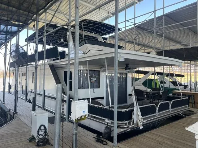 Slide: The Image of 2016 Sunstar 16x58 houseboat docked under covered marina. - 2