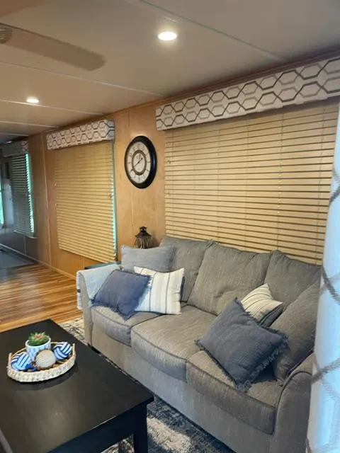 Slide: The Image of Cozy living area in a 2016 Sunstar 16x58 houseboat with modern decor and comfortable seating. - 20