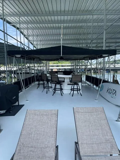 Slide: The Image of Spacious upper deck of 2016 Sunstar 16x58 houseboat with seating and canopy. - 21