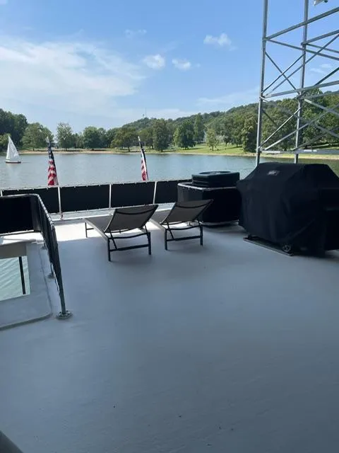 Slide: The Image of Spacious deck on 2016 Sunstar 16x58 houseboat with scenic lake view and lounge chairs. - 22