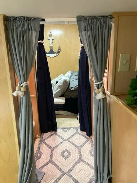 Slide: The Image of Interior of 2016 Sunstar 16x58 houseboat with cozy curtains and nautical decor. - 29