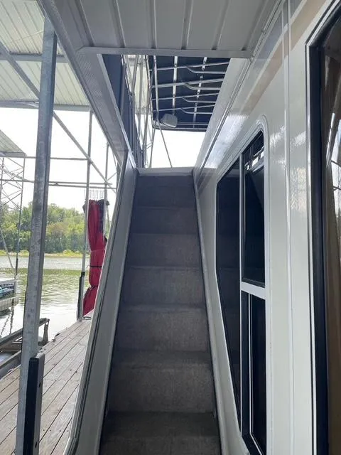 Slide: The Image of Staircase on 2016 Sunstar 16x58 houseboat, docked with scenic water view. - 3