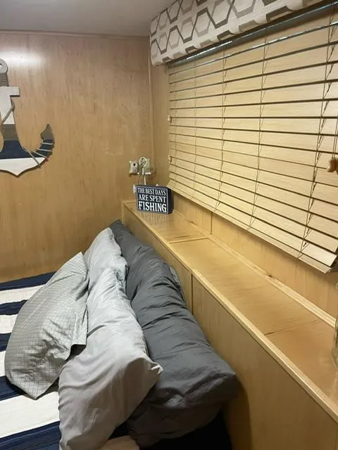 Slide: The Image of Cozy bedroom with nautical decor, striped bedding, and wooden blinds in a 2016 Sunstar 16x58. - 30