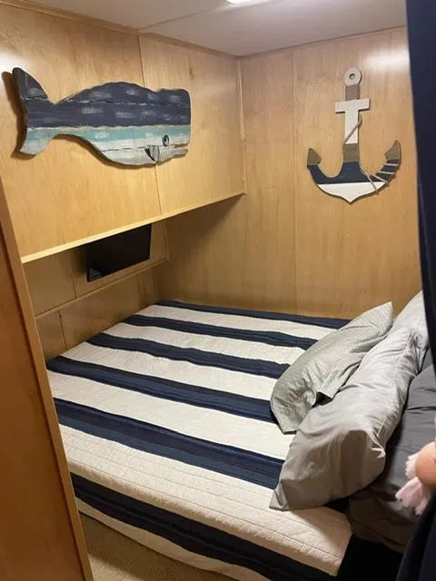 Slide: The Image of Cozy bedroom in 2016 Sunstar 16x58 houseboat with nautical decor and striped bedding. - 31