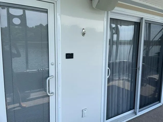 Slide: The Image of Exterior view of a 2016 Sunstar 16x58 houseboat with sliding glass doors. - 32