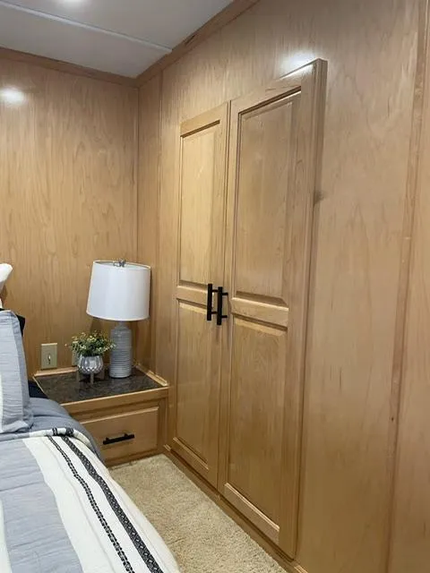 Slide: The Image of Wood-paneled bedroom interior with a lamp and cabinet, Sunstar 16x58, 2016 model. - 34