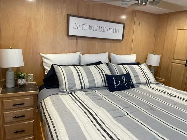 Slide: The Image of Cozy bedroom with striped bedding, decorative pillows, and wooden decor in a 2016 Sunstar 16x58. - 36