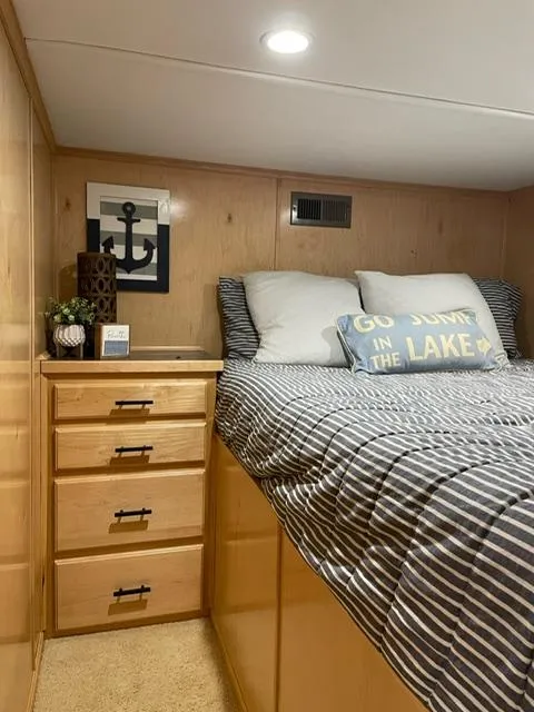 Slide: The Image of Cozy bedroom in 2016 Sunstar 16x58 houseboat with striped bedding and nautical decor. - 38