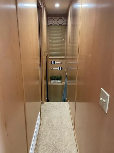 Slide: The Image of Narrow hallway inside 2016 Sunstar 16x58 houseboat with wooden walls and carpeted floor. - 39