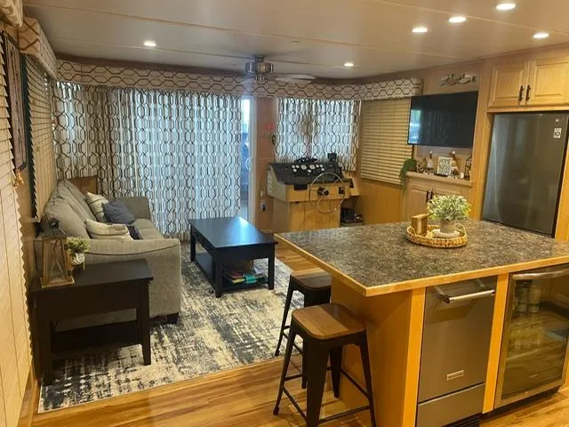 Slide: The Image of Modern Sunstar 16x58 houseboat interior with cozy living area, kitchen, and stylish decor, 2016 model. - 4