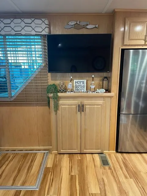 Slide: The Image of Modern houseboat interior with wooden cabinets, wall-mounted TV, and decorative accents. Sunstar 16x58, 2016 model. - 44