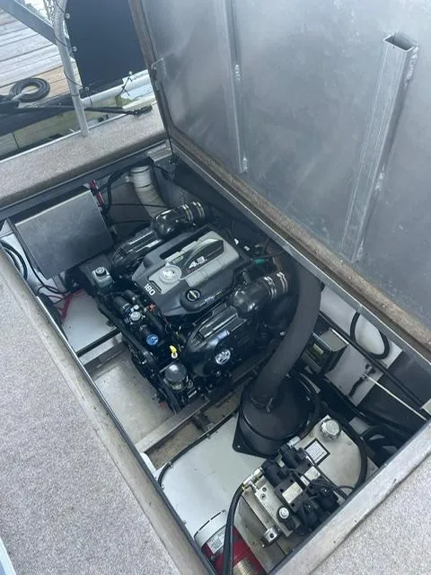 Slide: The Image of Engine compartment of a 2016 Sunstar 16x58 houseboat, showcasing mechanical components. - 46