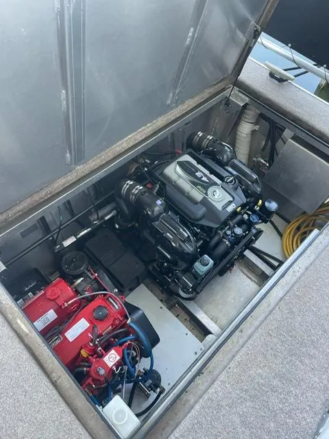 Slide: The Image of Engine compartment of a 2016 Sunstar 16x58 houseboat, showcasing dual engines and equipment. - 47