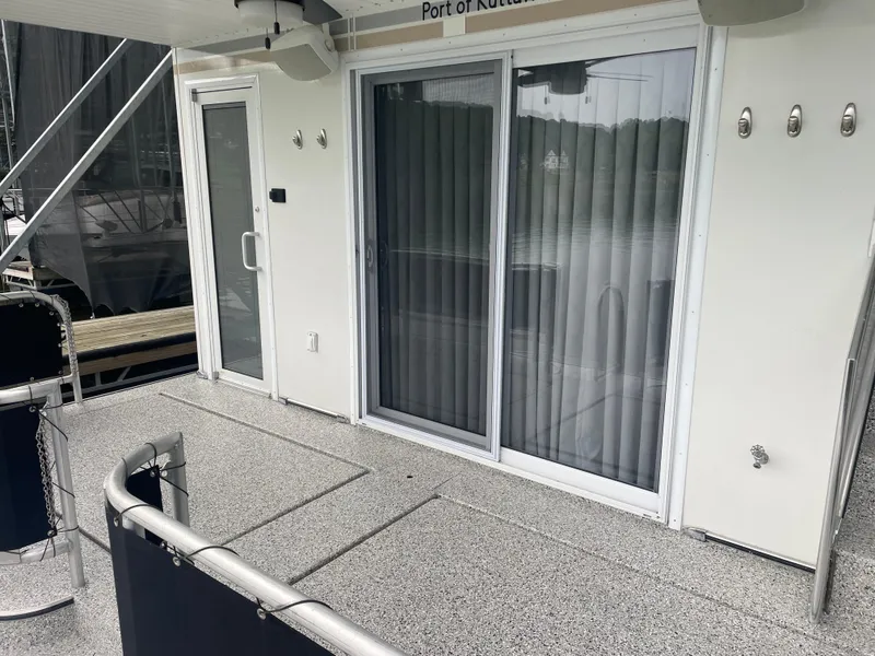 Slide: The Image of 2016 Sunstar 16x60 houseboat deck with sliding glass doors and railing. - 49