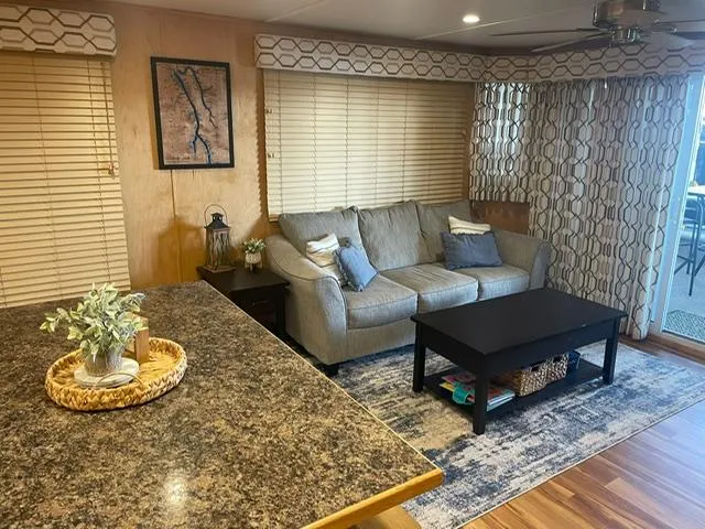 Slide: The Image of Cozy living area in a 2016 Sunstar 16x58 houseboat with modern decor and comfortable seating. - 6