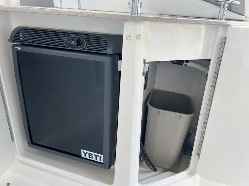 Slide: The Image of 2006 Sea Ray 290 Sundancer with Yeti cooler and storage compartment. - 12