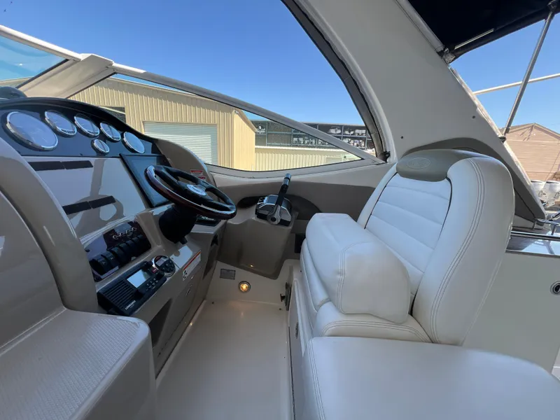 Slide: The Image of Interior view of 2006 Sea Ray 290 Sundancer boat cockpit with steering wheel and controls. - 18