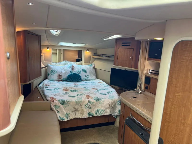 Slide: The Image of Interior of 2006 Sea Ray 290 Sundancer with cozy bed and kitchenette. - 25
