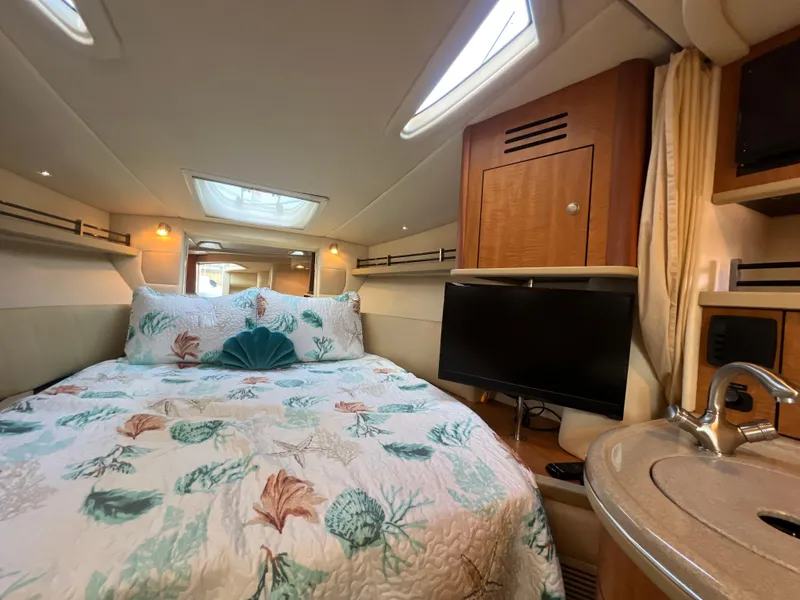 Slide: The Image of Luxurious cabin interior of 2006 Sea Ray 290 Sundancer with cozy bed and modern amenities. - 28