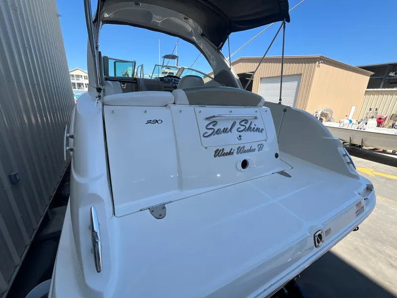 Slide: The Image of 2006 Sea Ray 290 Sundancer boat docked, featuring sleek design and spacious deck. - 3