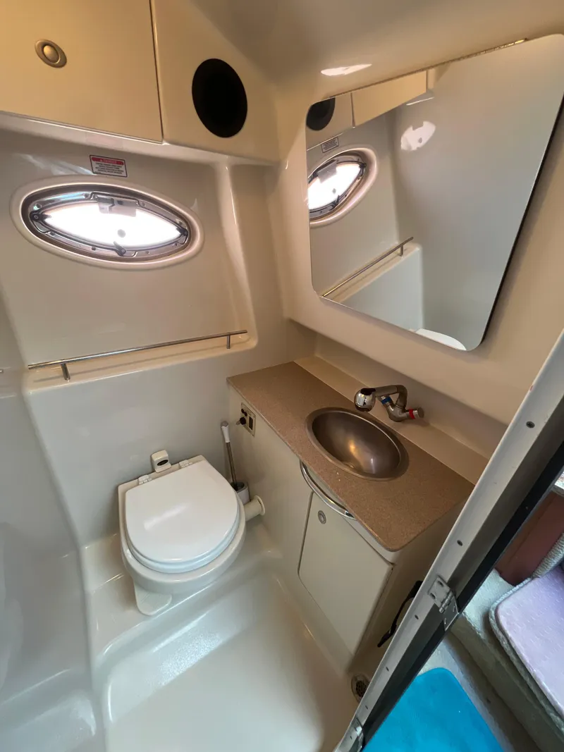 Slide: The Image of 2006 Sea Ray 290 Sundancer bathroom with sink, toilet, and mirror. - 30