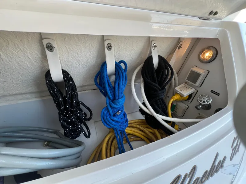 Slide: The Image of Storage compartment on a 2006 Sea Ray 290 Sundancer with organized ropes and cables. - 35