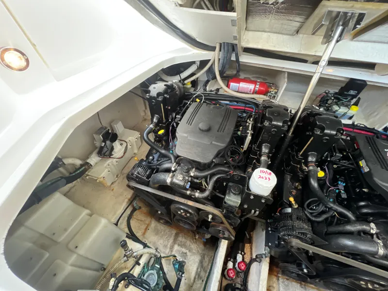 Slide: The Image of Engine compartment of a 2006 Sea Ray 290 Sundancer boat, showcasing dual engines and equipment. - 37