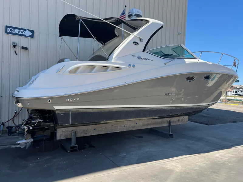 Slide: The Image of 2006 Sea Ray 290 Sundancer boat on dry dock, side view, with a "One Way" sign nearby. - 44