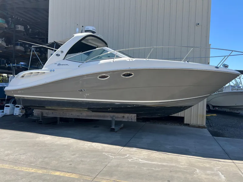 Slide: The Image of 2006 Sea Ray 290 Sundancer boat on display in a marina setting. - 45