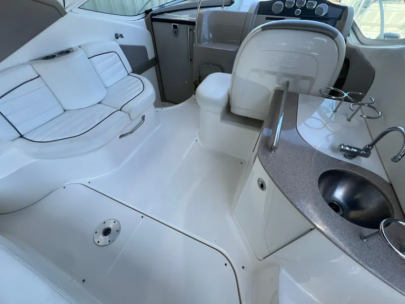 Slide: The Image of 2006 Sea Ray 290 Sundancer interior with seating, sink, and helm. - 8