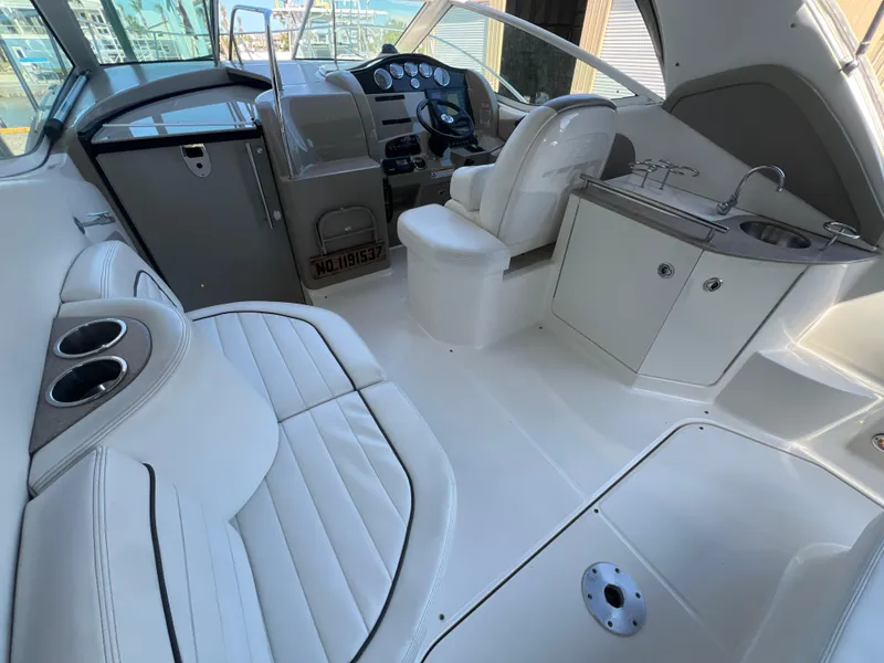 Slide: The Image of 2006 Sea Ray 290 Sundancer interior with seating, helm, and kitchenette. - 9