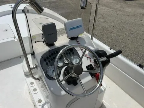 Slide: The Image of 2012 Carolina Skiff JVX18CC boat console with steering wheel and navigation equipment. - 6